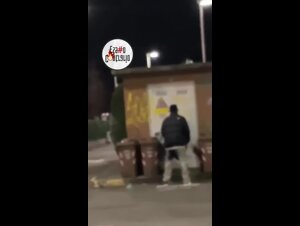 Ragazzi in macchina filmano una coppia che scopa vicino ai bidoni dell'immondizia